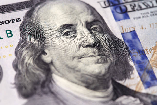istock Benjamin Franklin close-up portrait on dollar banknote. 941505036