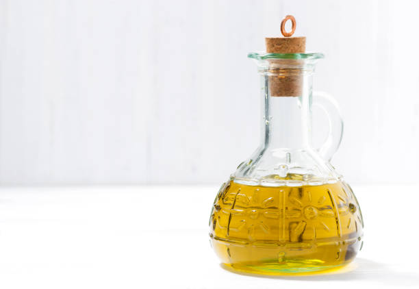 istock bottle of olive oil on a white table 941505334