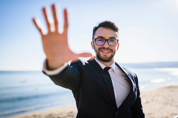 istock Lonely entrepreneur reaching for you on the beach 941508518