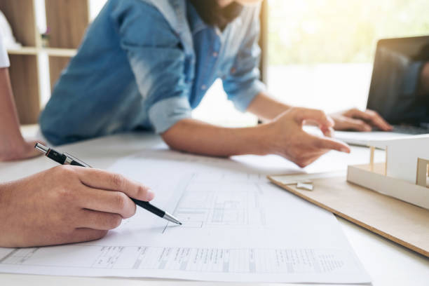 istock Architect working on blueprint, Engineer meeting working with partner colleagues and engineering tools for architectural project, Construction concept 941511358