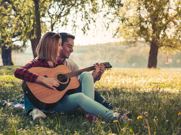 istock Man playing guitar to his girl 941512086