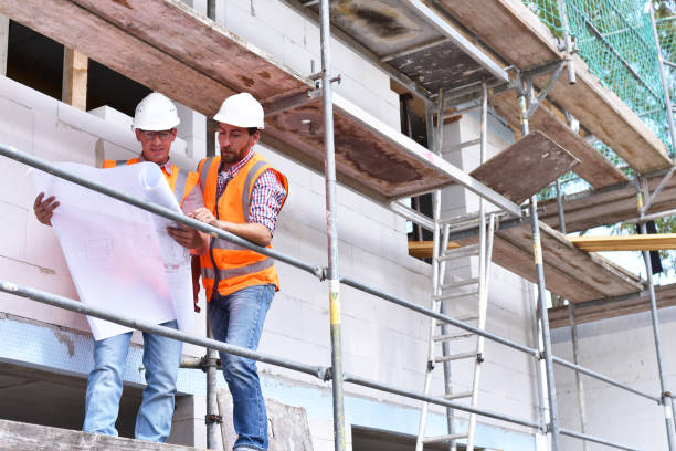 istock teamwork on the construction site - site manager and architect on site during the construction of a house 941514506