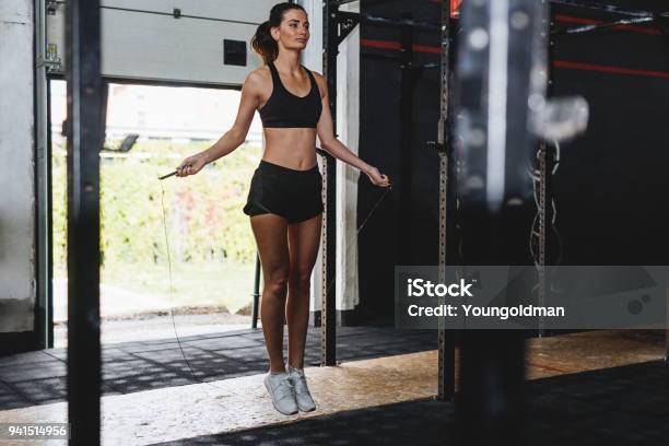 Sporty Woman Doing Fitness Training With Jump Rope In Gym Stock Photo - Download Image Now