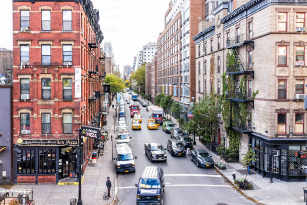 aerial view of modern chelsea neighborhood apartment buildings and cars in traffic on street below in new york, manhattan, nyc - chelsea new york imagens e fotografias de stock