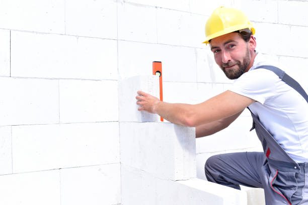 istock craftsmen at home construction - bricklayers working in work clothes 941515418