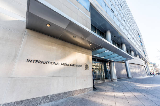 IMF entrance with sign of International Monetary Fund, concrete architecture building wall security guard doors Washington DC, USA - March 9, 2018: IMF entrance with sign of International Monetary Fund, concrete architecture building wall security guard doors headquarters photos stock pictures, royalty-free photos & images