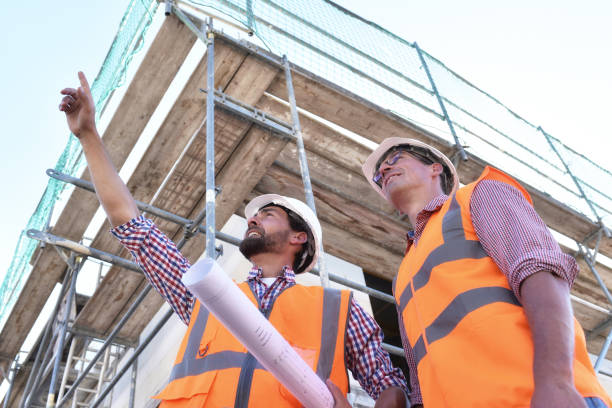 istock teamwork on the construction site - site manager and architect on site during the construction of a house 941518004