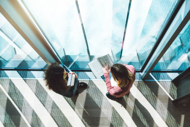 Modern library Two women standing in the modern library architecture built structure futuristic contemporary stock pictures, royalty-free photos & images