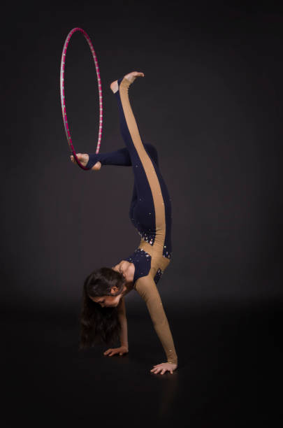 istock Gymnastic exercises with hula Hoop girl performs a circus artist. 941523036