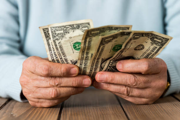 istock Senior Woman Counting Money 941523680