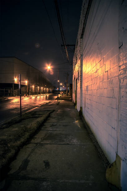 istock Dark scary city sidewalk at night 941531646