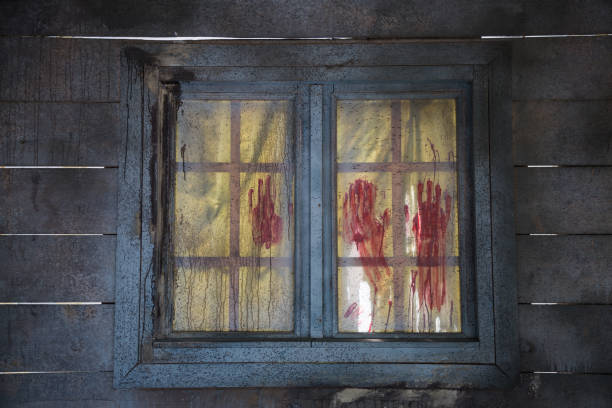 Bloodstained Red Fingerprints on Closed Wooden Window.