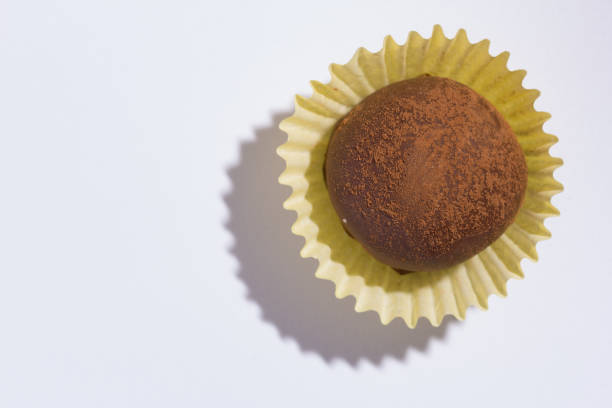 istock Homemade chocolate truffle.  Flat lay of candy ball on white table. 941552846