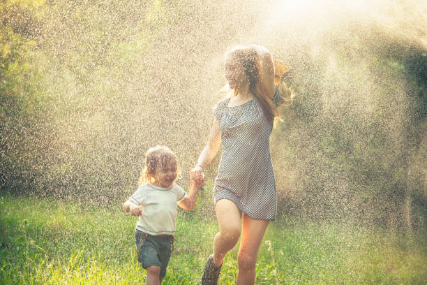 istock Mother and child running in the rain 941552980