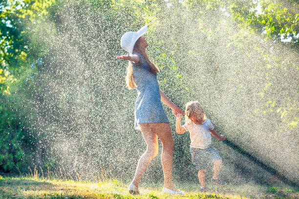 istock Mother and child having fun in the rain 941553050