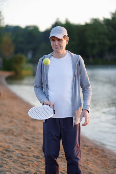 istock Man playing beach tennis 941557652