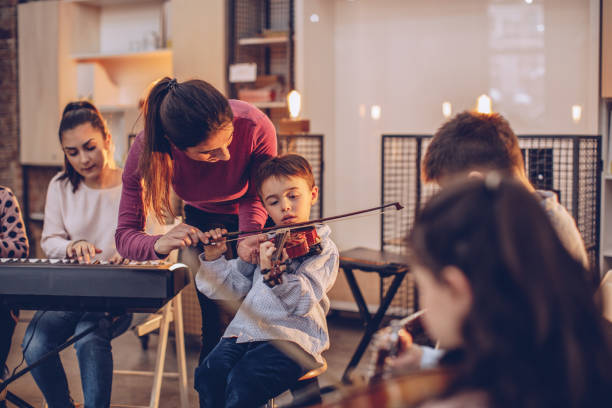 istock Children learning in music school 941559530