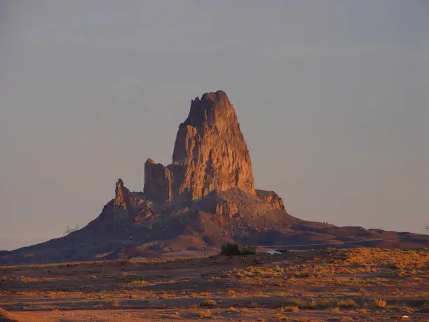 Agathla Peak is the 1436 foot remnant of an eroded volcano, being the lava plug that formed inside.  The peak is south of Monument Valley, 7 miles north of Kayenta on the Navajo Reservation.  This photograph was taken from U.S. Route 163 the morning of November 5, 2003.