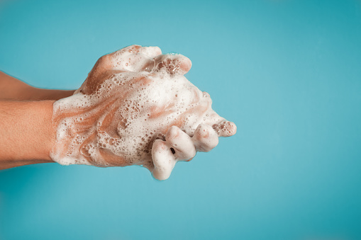 Man washing hands, studio shot.