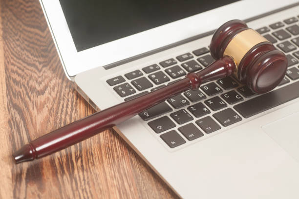 istock Judge gavel with laptop computer on wooden background 941570126