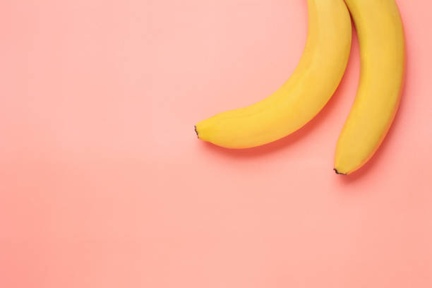 istock Bunch of bananas on colorful background 941571384