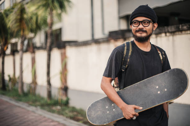 istock Young man holding a skateboard outdoors 941574456