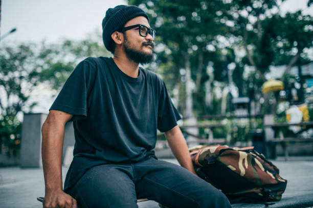 istock Skater man sitting at skate park 941574720
