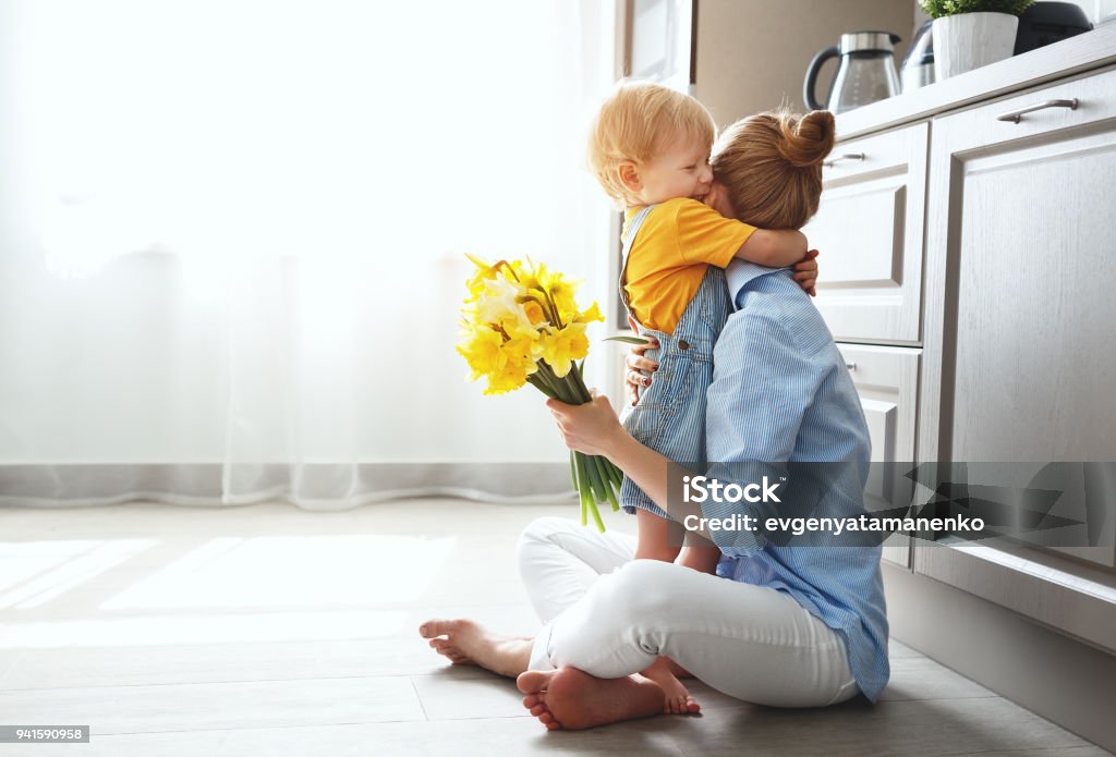 happy mother's day! baby son gives flowersfor  mother on holiday happy mother's day! baby son congratulates mother on holiday and gives flowers Mother Stock Photo