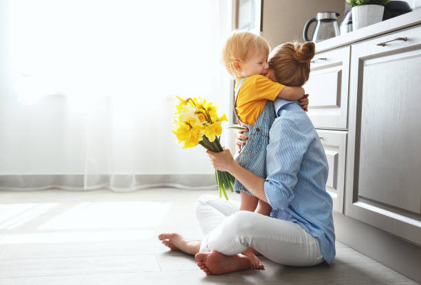 happy mother's day! baby son gives flowersfor  mother on holiday - mother gift imagens e fotografias de stock