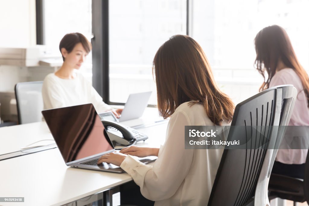 asian businesswomen working in office Laptop Stock Photo