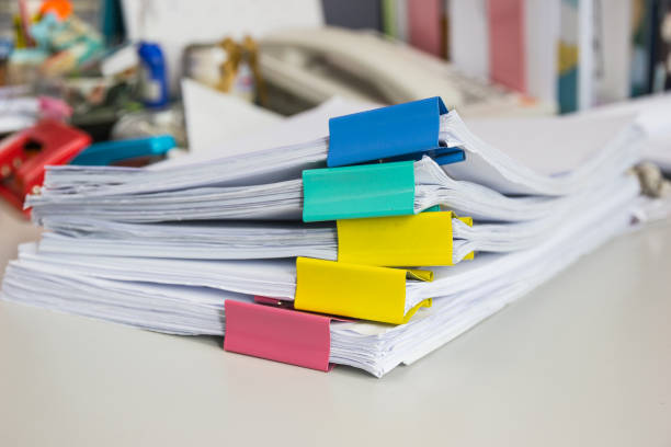 istock Stack of papers documents in archives files with paper clips on desk at offices, business concept. 941594210