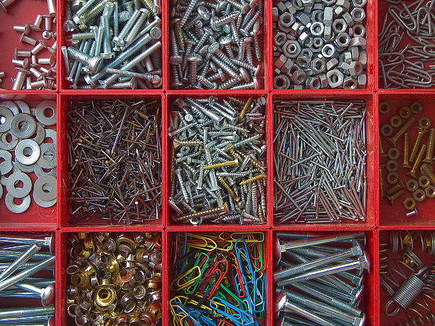 Objects; Organized nails, pins and screws Red boxes with asorted nails, pins, screws and more. bolt fastener photos stock pictures, royalty-free photos & images