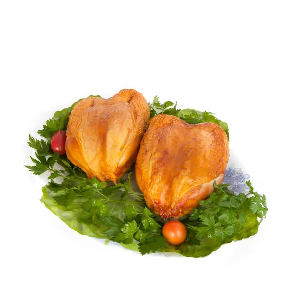 Smoked chicken breast on lettuce leaves.. Isolated on white background.