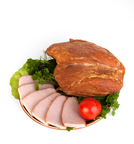 istock Sliced smoked meat on a plate with greens. On a white background. 941596054