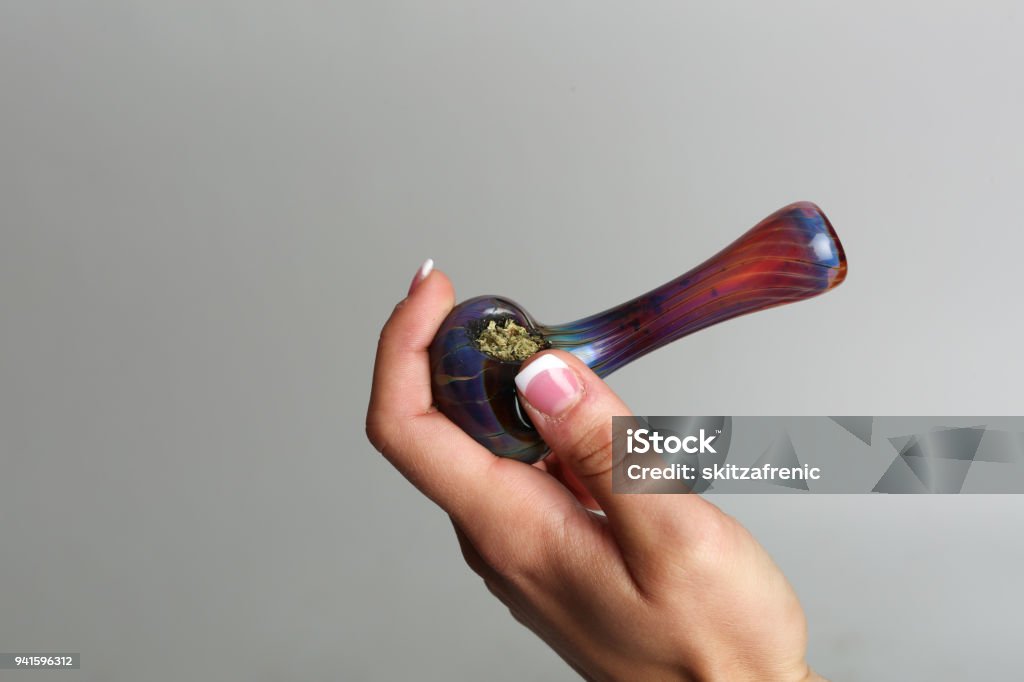 Marijuana pipe in a hand Cannabis Plant Stock Photo