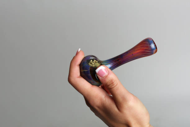 Marijuana pipe in a hand Marijuana pipe in a hand bong stock pictures, royalty-free photos & images