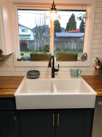 Amazing farmhouse sink oversized with a large window above it at a house remodel and renovation in Oregon.