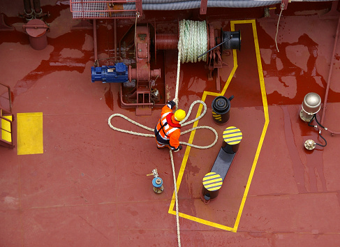 Ancona, Marche, Italy - April 29, 2006: Pilot at Work: Boarding a Ship Entering the Port. A daring professional pilot in action, braving the challenges of jumping onto a moving ship and climbing to the doors. Ensuring safe and smooth navigation into the harbor of Ancona for every ship or ferry.
