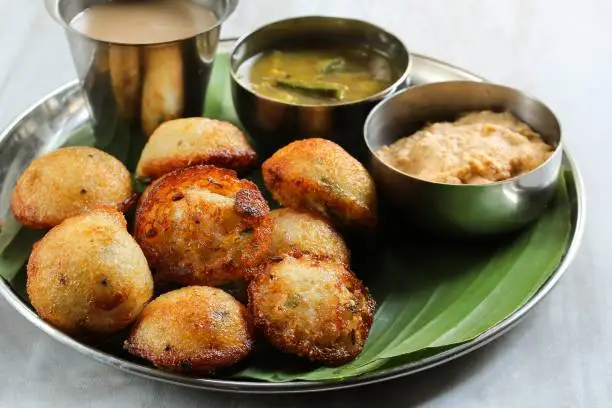 Photo of Kuzhi Paniyaram served with coconut chutney and sambar- South Indian breakfast with black  lentils and rice