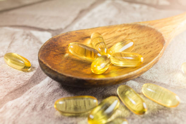istock Capsules on wooden spoon 941624802