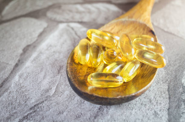 istock Capsules on wooden spoon 941624804