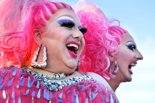 Happy Drag queens laughing Auckland: Happy drag queens laughing. A drag queen is a male who dresses in clothing of the opposite sex, acts with exaggerated femininity in feminine gender roles for entertainment or fashionHappy drag queens laughing. A drag queen is a male who dresses in clothing of the opposite sex, acts with exaggerated femininity in feminine gender roles for entertainment or fashion diva human role stock pictures, royalty-free photos & images