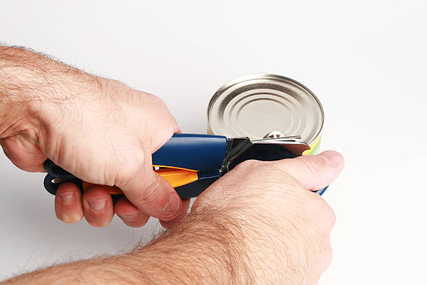 istock can opener and hands of man 94162733