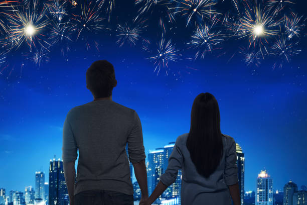 istock Romantic asian couple enjoying fireworks view 941642032