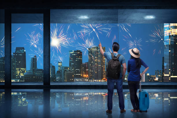 istock Happy asian traveler couple watching fireworks 941642402