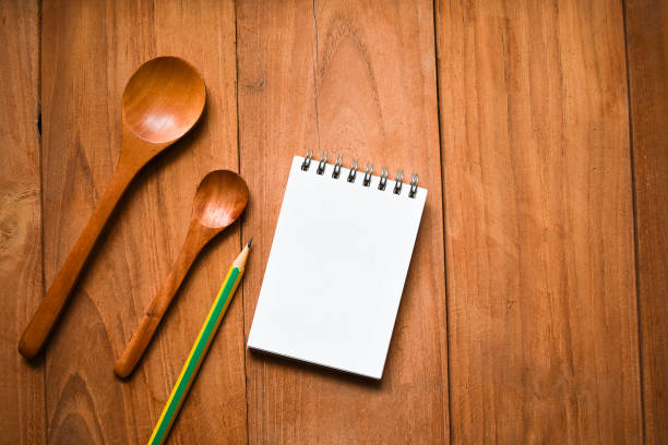istock Notepad with spoon and pencil on wood board background.using wallpaper for education, business photo.Take note of 