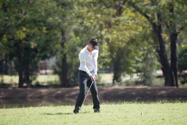 istock Golfers asia man show hit sweeping at green lawn 941650738