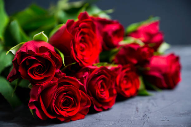 istock Bouquet with red roses on the rustic background 941653412