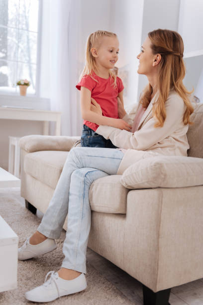 istock Pleasant nice woman looking at her daughter 941659180