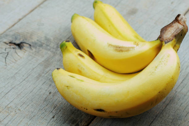 istock Yellow banana on wooden. 941664286